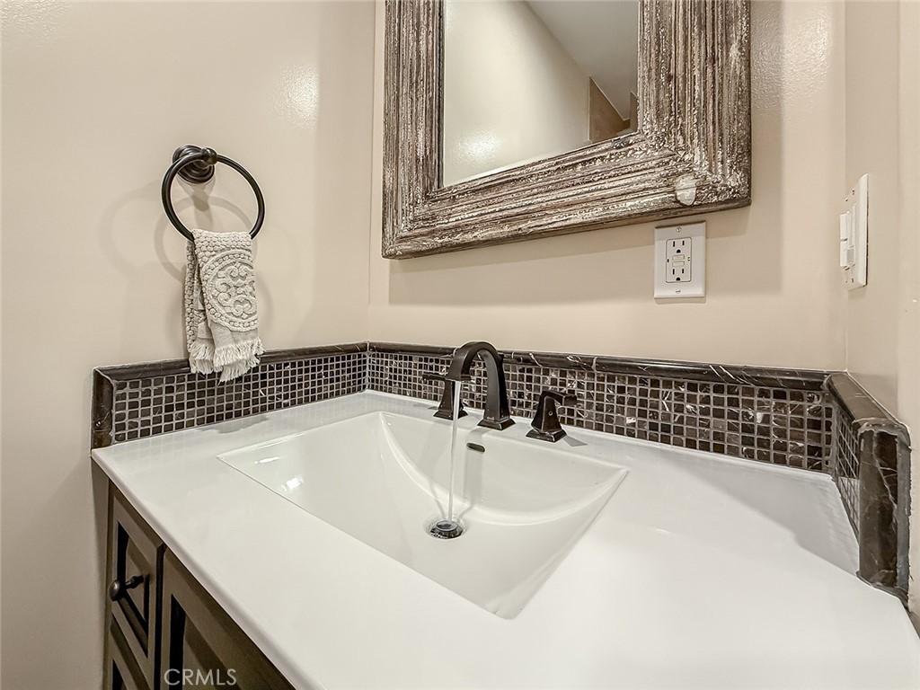 5960 Balcom Avenue Encino, CA 91316 - Photo 22 of 58 a bathroom with a sink and a mirror