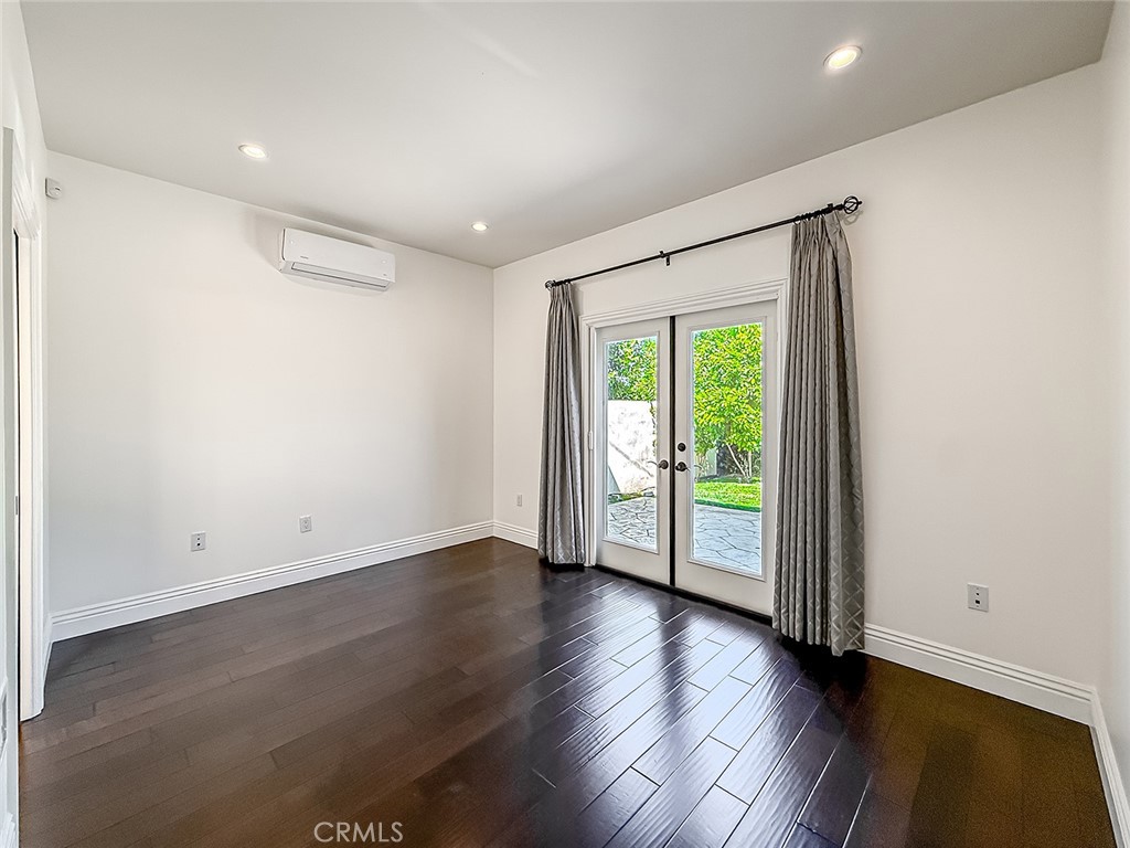 5960 Balcom Avenue Encino, CA 91316 - Photo 25 of 58 an empty room with wooden floor and sliding door