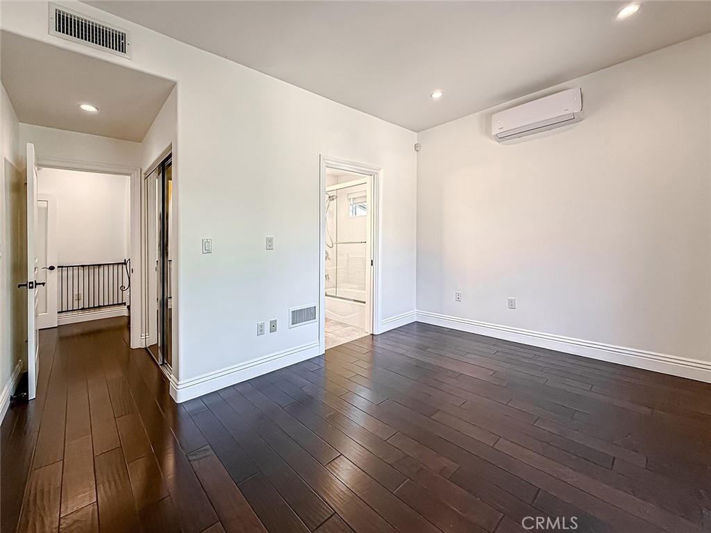 5960 Balcom Avenue Encino, CA 91316 - Photo 26 of 58 an empty room with wooden floor and windows