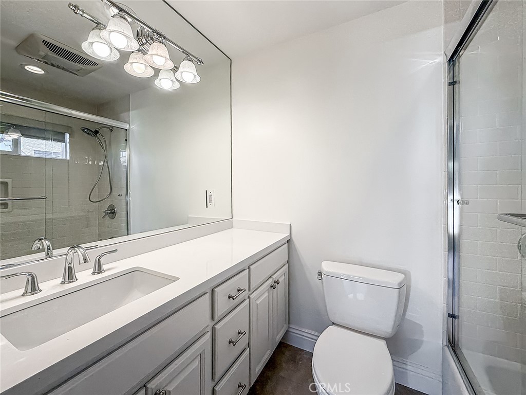 5960 Balcom Avenue Encino, CA 91316 - Photo 27 of 58 a bathroom with a toilet a sink and mirror