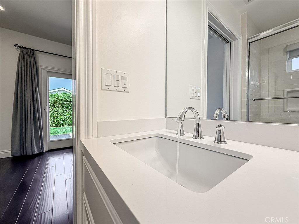 5960 Balcom Avenue Encino, CA 91316 - Photo 28 of 58 a bathroom with a sink and a large mirror