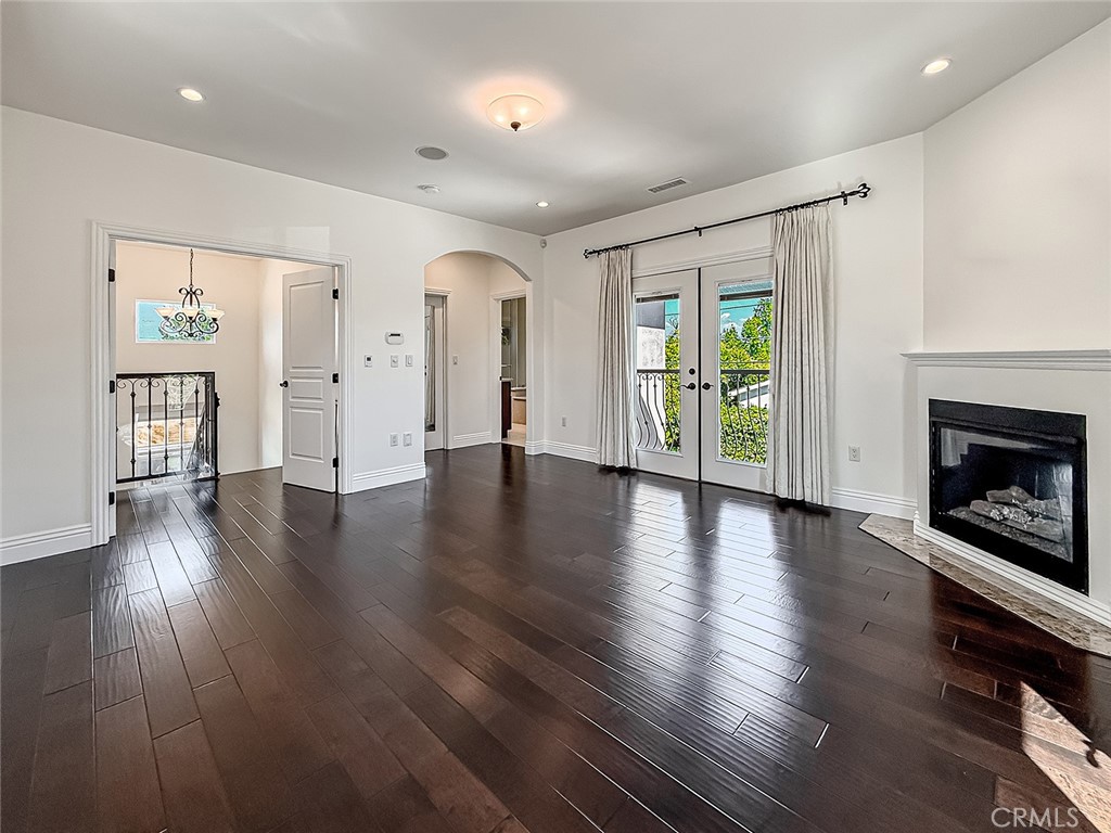 5960 Balcom Avenue Encino, CA 91316 - Photo 31 of 58 an empty room with wooden floor and a fireplace