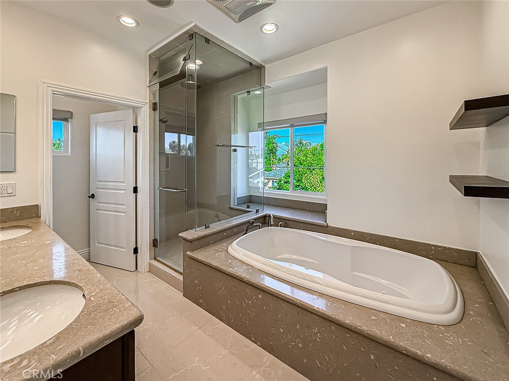 5960 Balcom Avenue Encino, CA 91316 - Photo 38 of 58 a spacious bathroom with a granite countertop tub sink and mirror