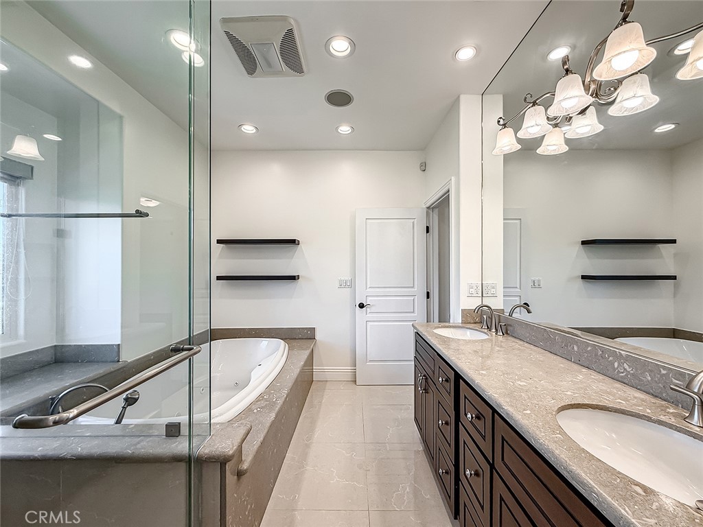 5960 Balcom Avenue Encino, CA 91316 - Photo 42 of 58 a bathroom with a granite countertop sink a large mirror and shower