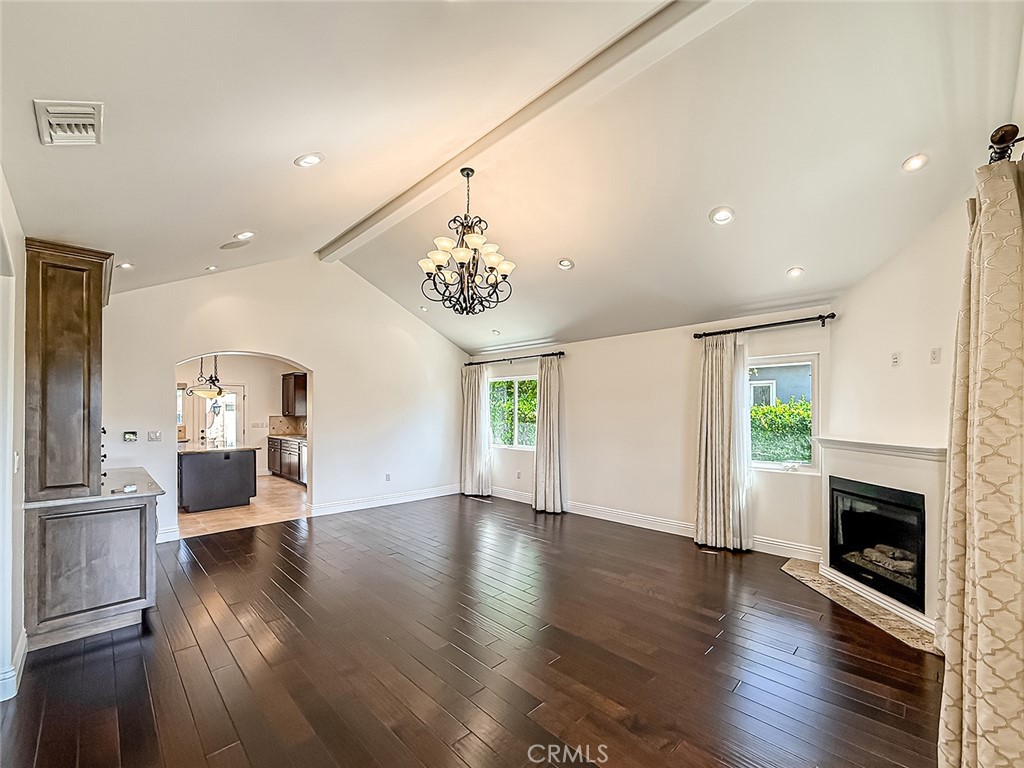 5960 Balcom Avenue Encino, CA 91316 - Photo 5 of 58 a view of an empty room with wooden floor and a kitchen