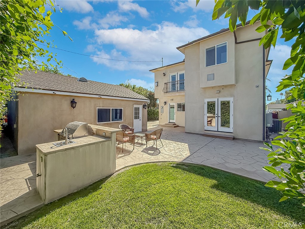 5960 Balcom Avenue Encino, CA 91316 - Photo 51 of 58 a view of a house with backyard sitting area and garden
