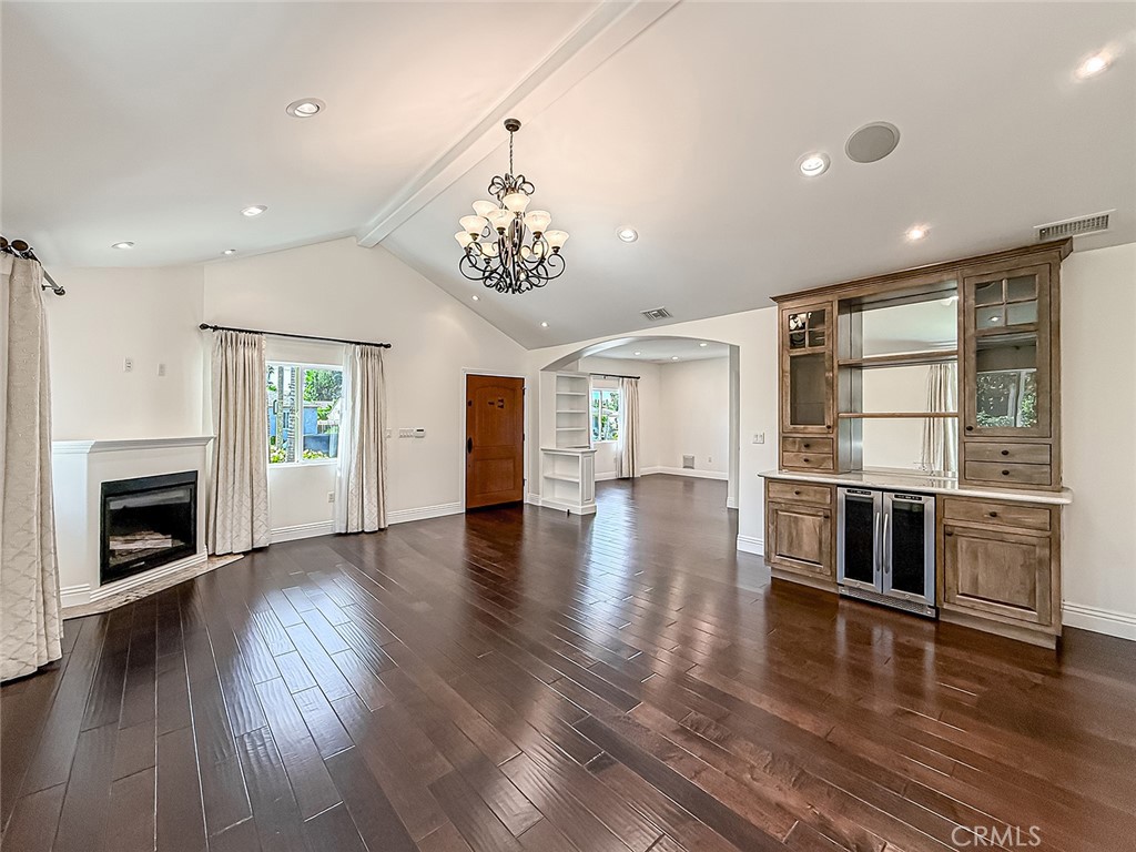 5960 Balcom Avenue Encino, CA 91316 - Photo 7 of 58 an empty room with wooden floor fireplace and windows