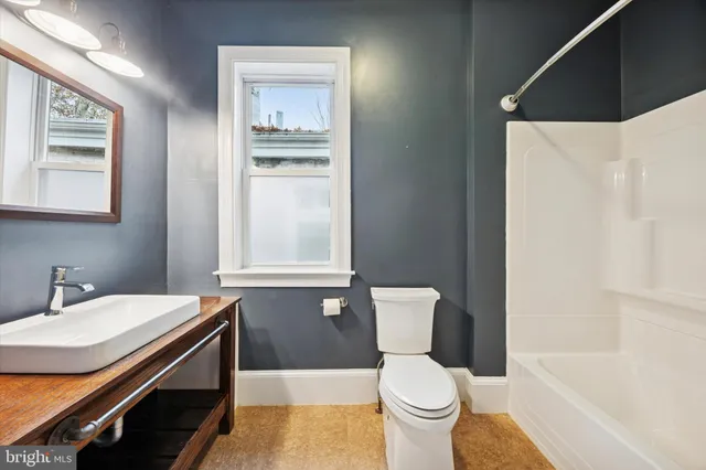 a bathroom with a sink toilet and vanity