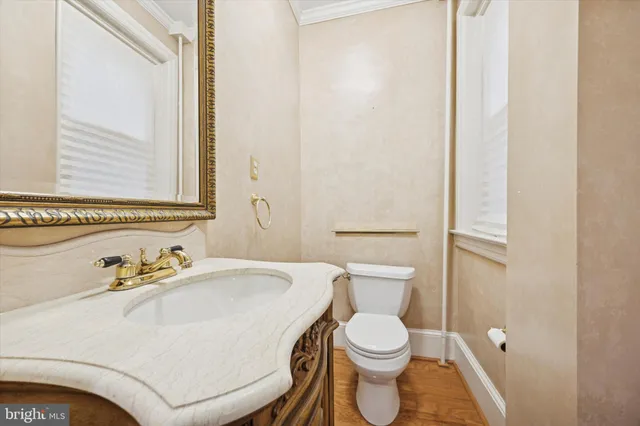a white toilet sitting next to a bathroom sink