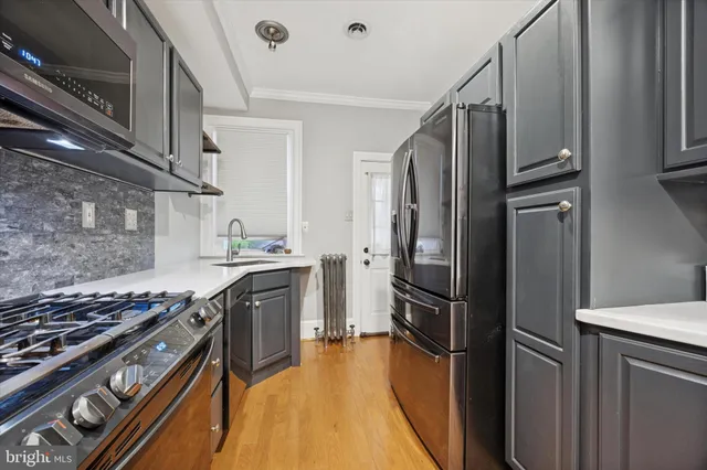 a kitchen with stainless steel appliances granite countertop a stove and a refrigerator