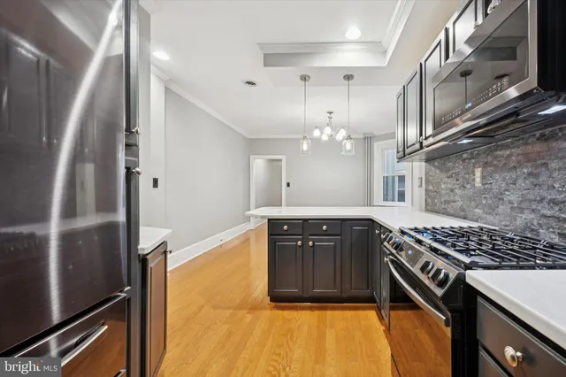 a kitchen with stainless steel appliances granite countertop a stove a refrigerator and a oven