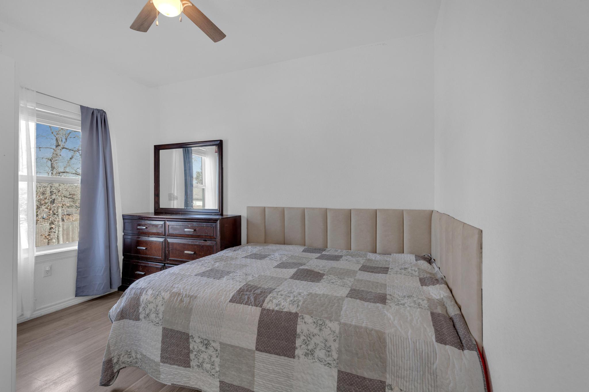 114 Crepe Myrtle Parkway Elgin, TX 78621 - Photo 27 of 40 Unit B - Bedroom with wood finished floors and ceiling fan