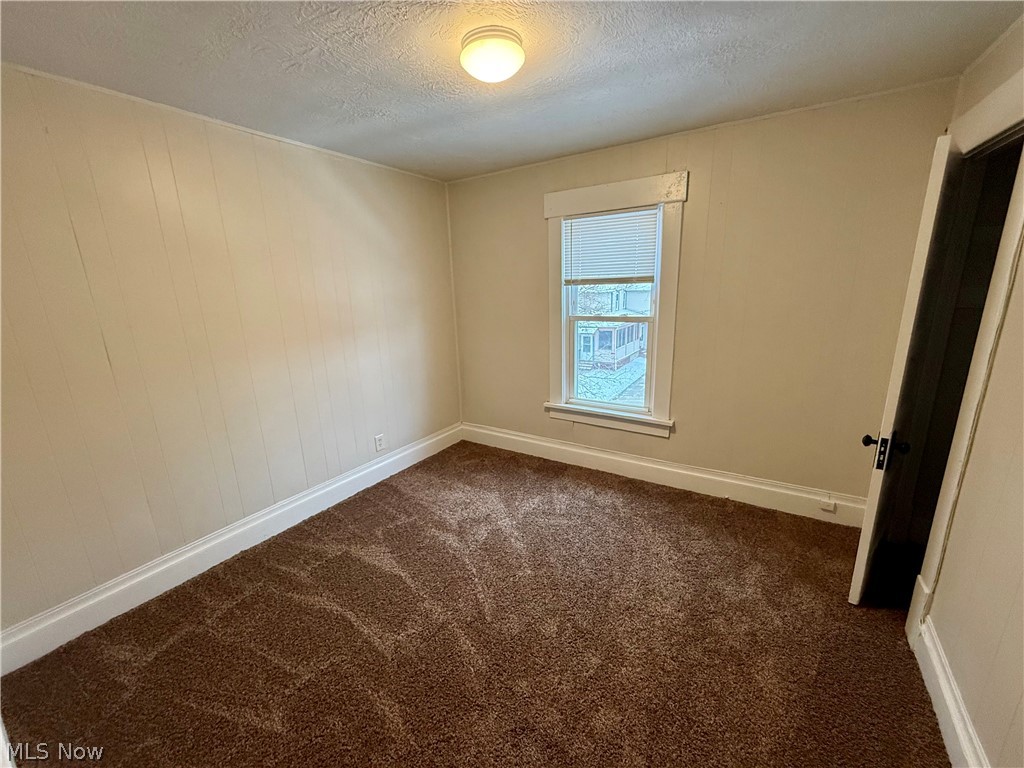 39 North Balch Street Akron, OH 44303 - Photo 15 of 19 Unfurnished room with a textured ceiling and dark colored carpet