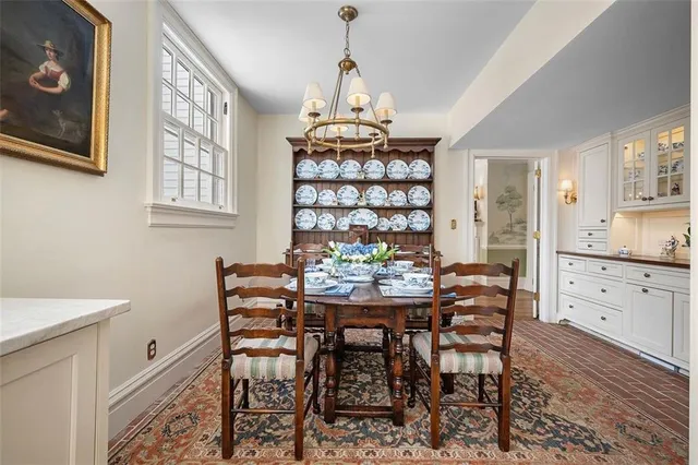 a living room with furniture flat screen tv and a large window
