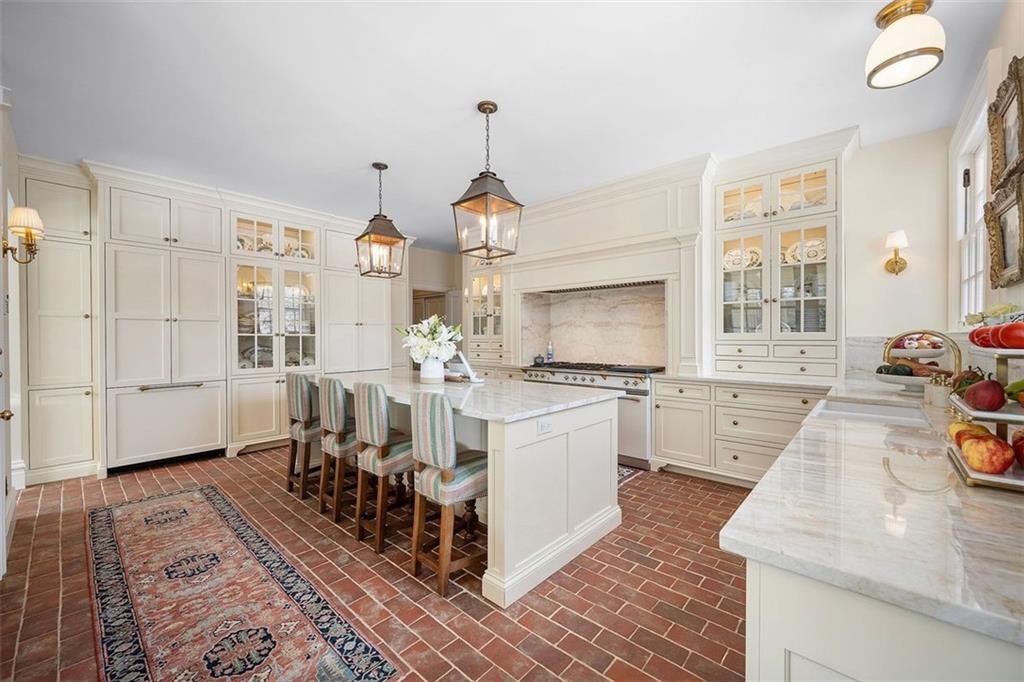 526 Scaife Road Sewickley, PA 15143 - Photo 7 of 50 a large white kitchen with granite countertop a stove a sink a window and a dining table
