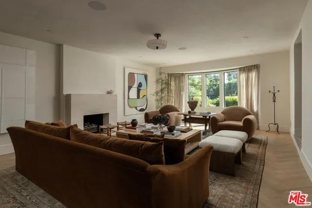 a view of patio with couches table and chairs potted plants and swimming pool