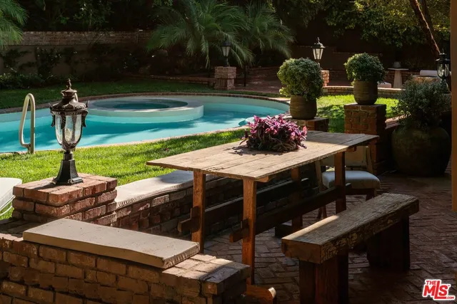 a living room with a table and a potted plant