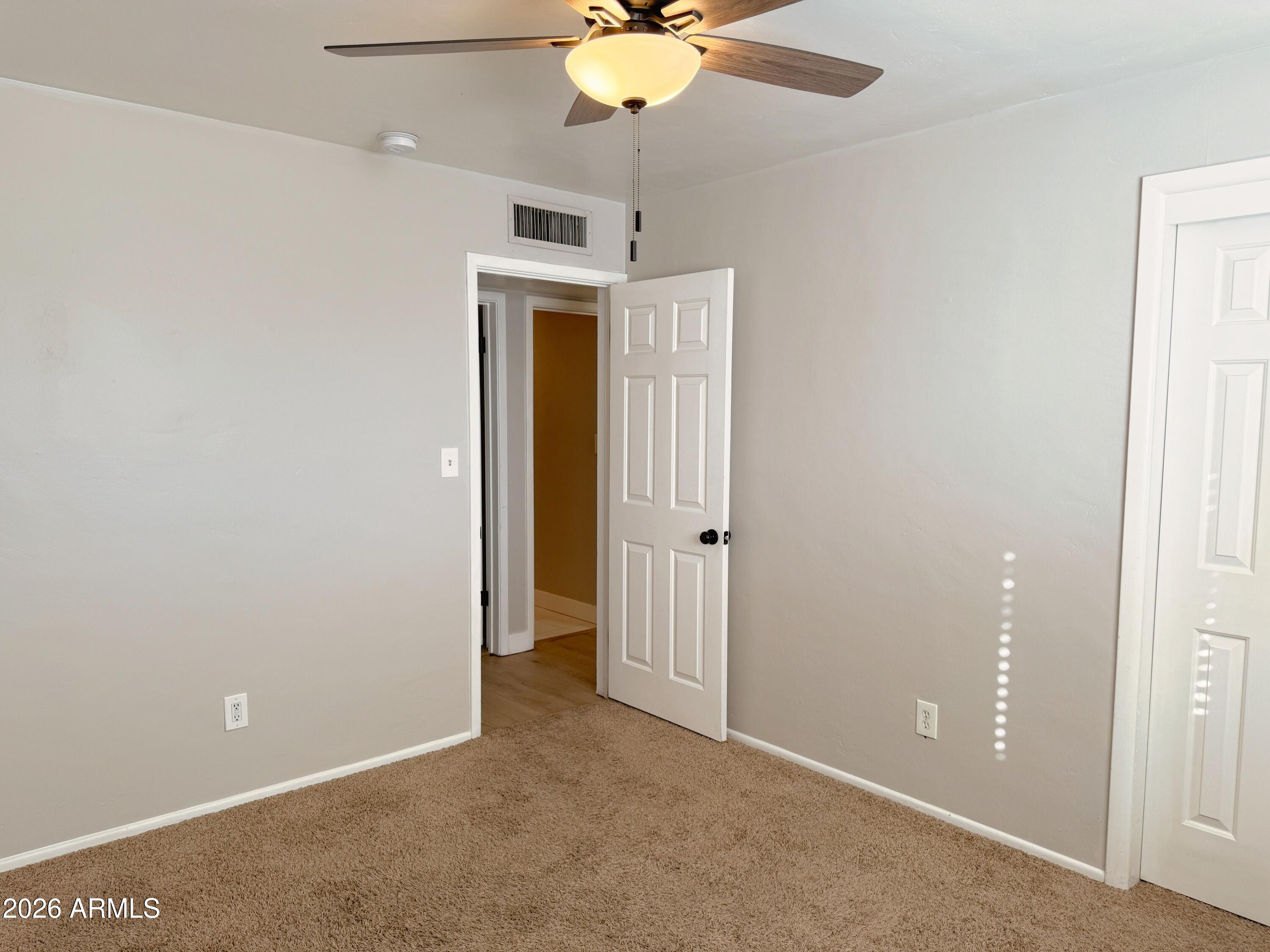 1220 West Romo Jones Street Tempe, AZ 85281 - Photo 18 of 26 a view of an empty room with a ceiling fan