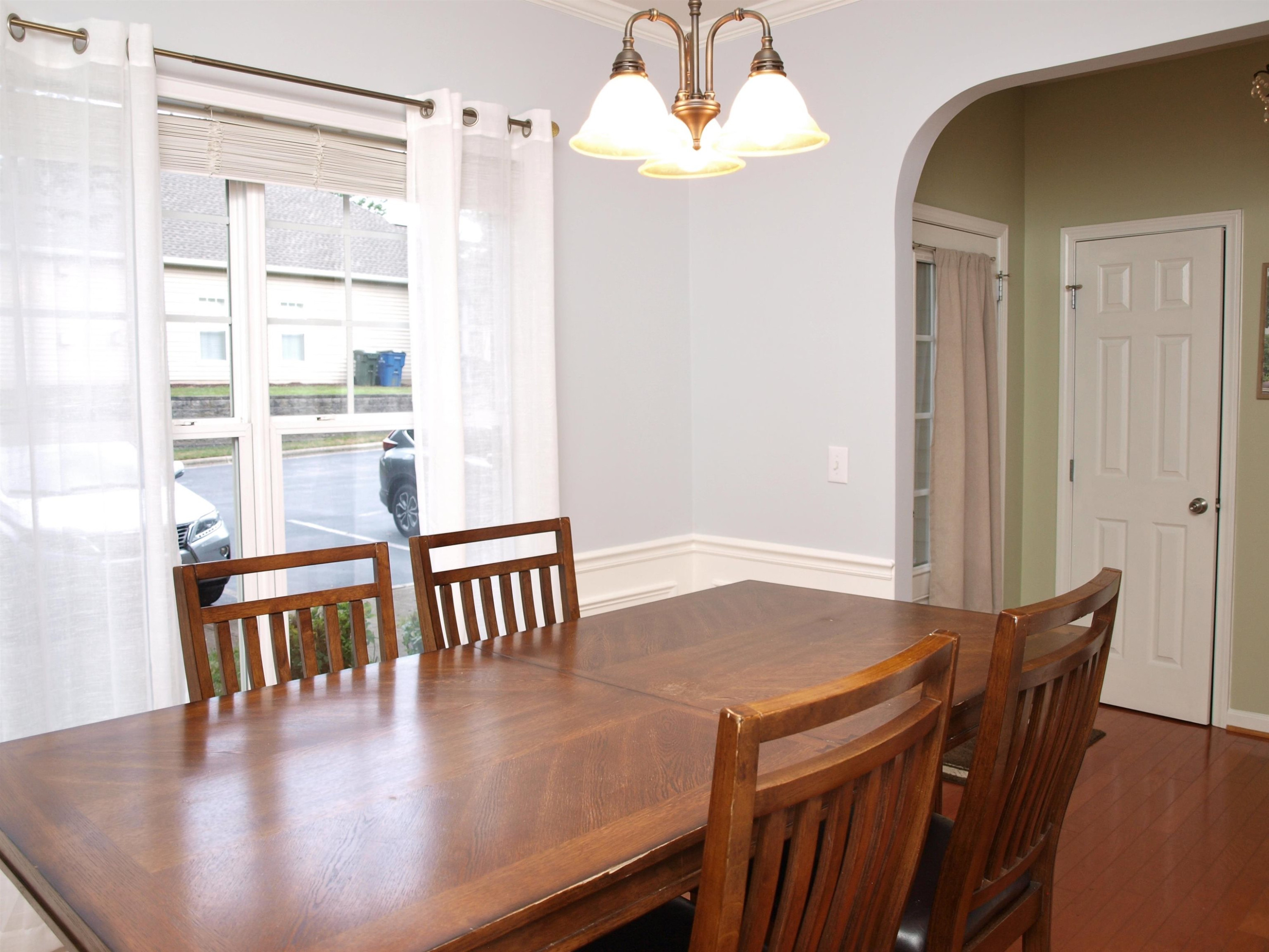 11259 Lofty Heights Place Raleigh, NC 27614 - Photo 2 of 18 a view of a dining room with furniture and wooden floor
