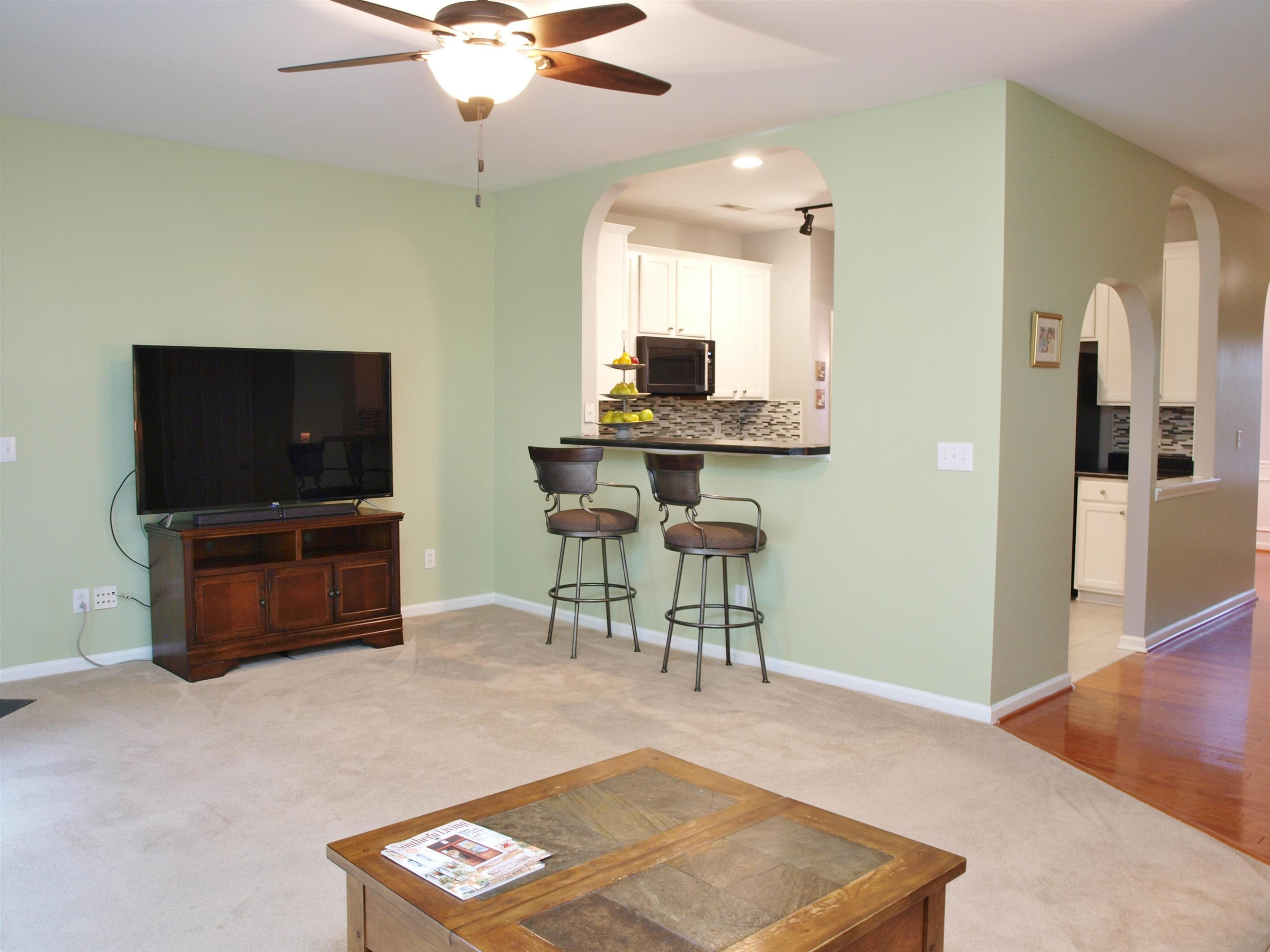 11259 Lofty Heights Place Raleigh, NC 27614 - Photo 6 of 18 a living room with furniture and a flat screen tv