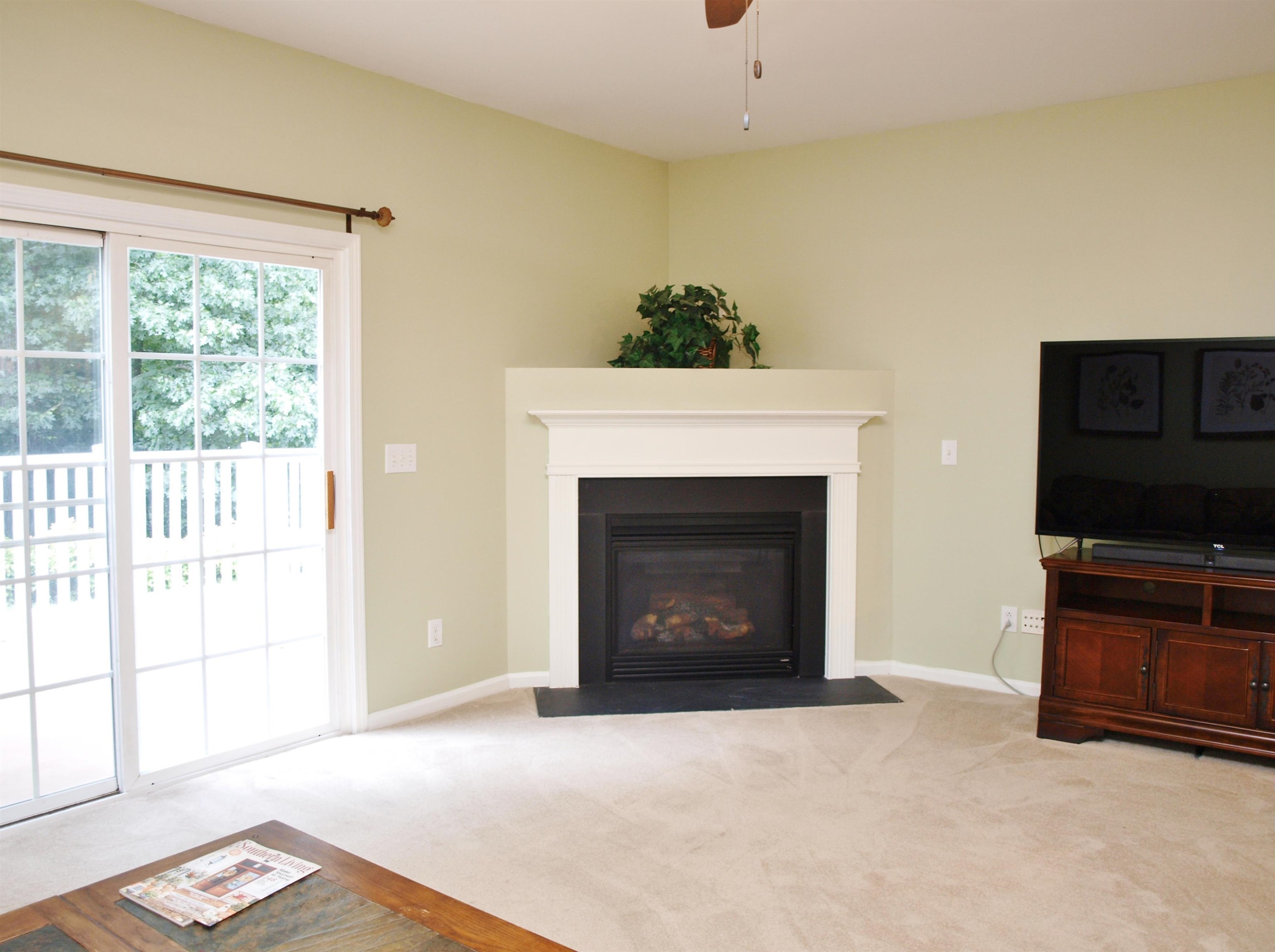 11259 Lofty Heights Place Raleigh, NC 27614 - Photo 7 of 18 a living room with a fireplace and a flat screen tv