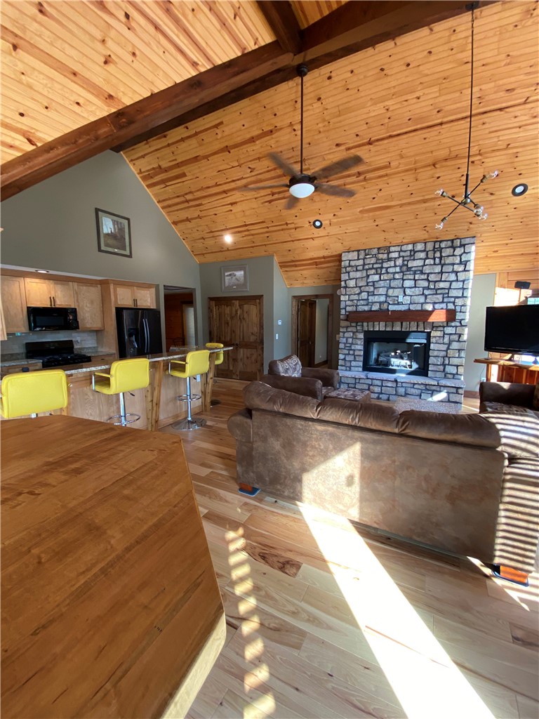 128 McAlister Road West Union, SC 29696 - Photo 6 of 40 A spacious great room showcases soaring vaulted ceilings and a captivating stone fireplace.