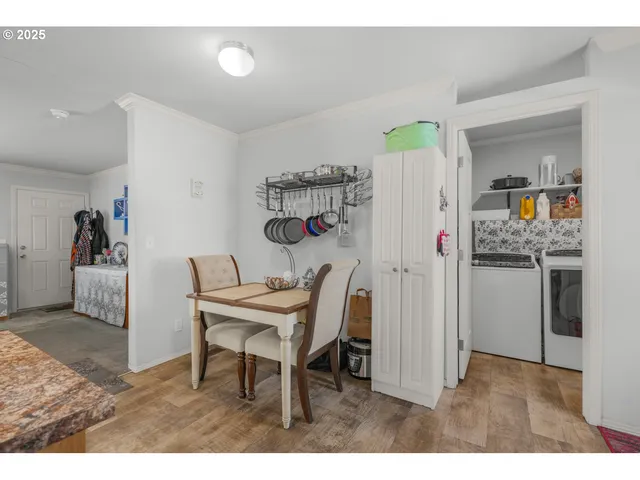 a bedroom with a bed a chair and painting on the wall