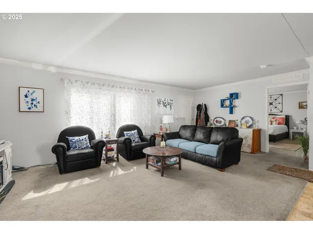a living room with furniture a couch and a window