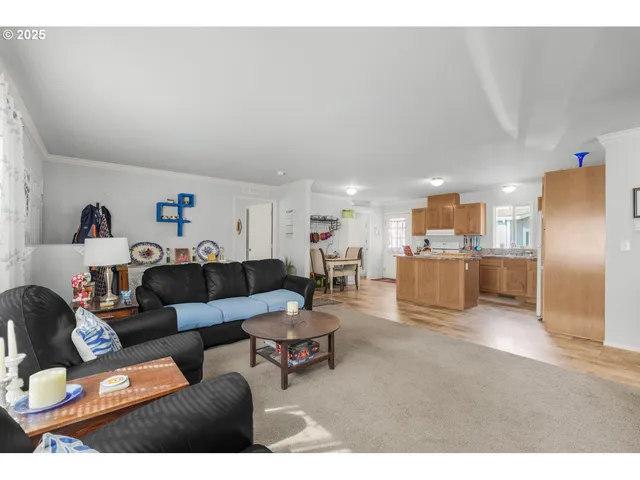 a living room with furniture and kitchen view
