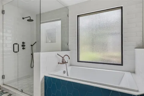 a bathroom with a bathtub and a shower