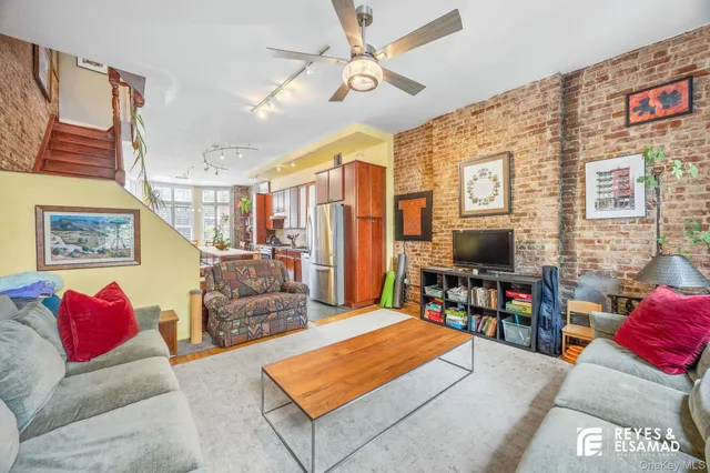 a living room with furniture a flat screen tv and a flat screen tv