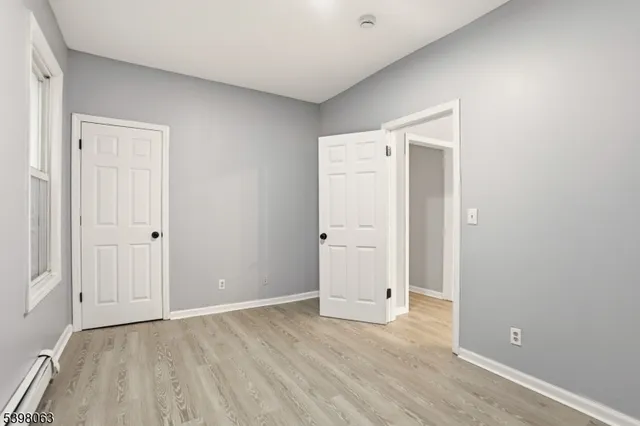 an empty room with wooden floor