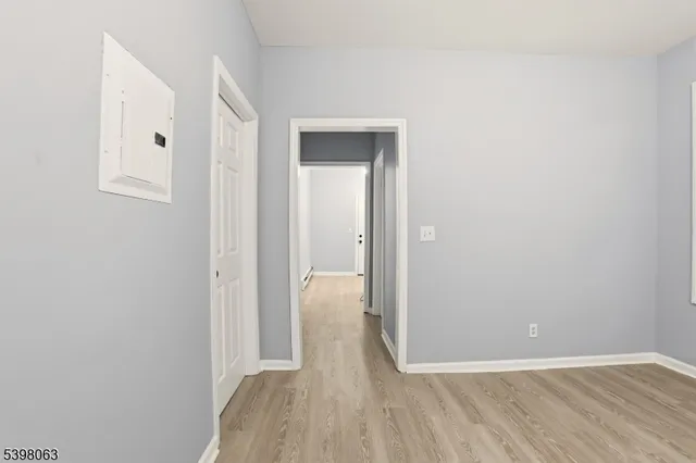 a view of a room with wooden floor