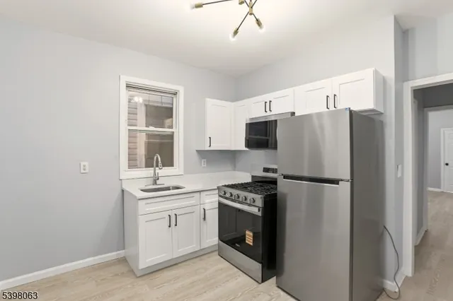 a kitchen with a stove a refrigerator and a sink