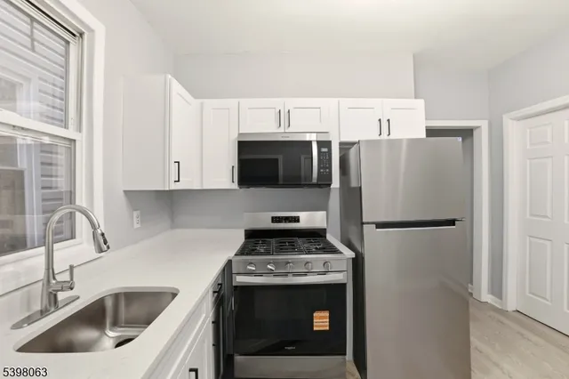 a kitchen with a refrigerator sink and stove