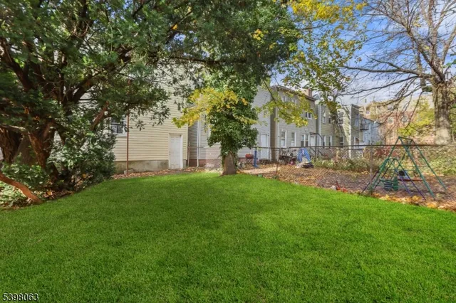a view of a yard with a tree
