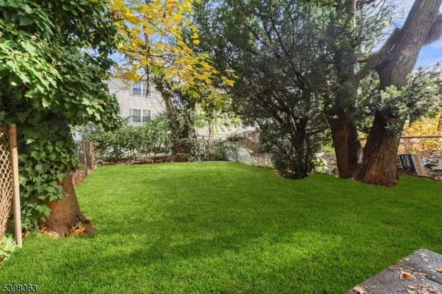 a view of backyard with swimming pool
