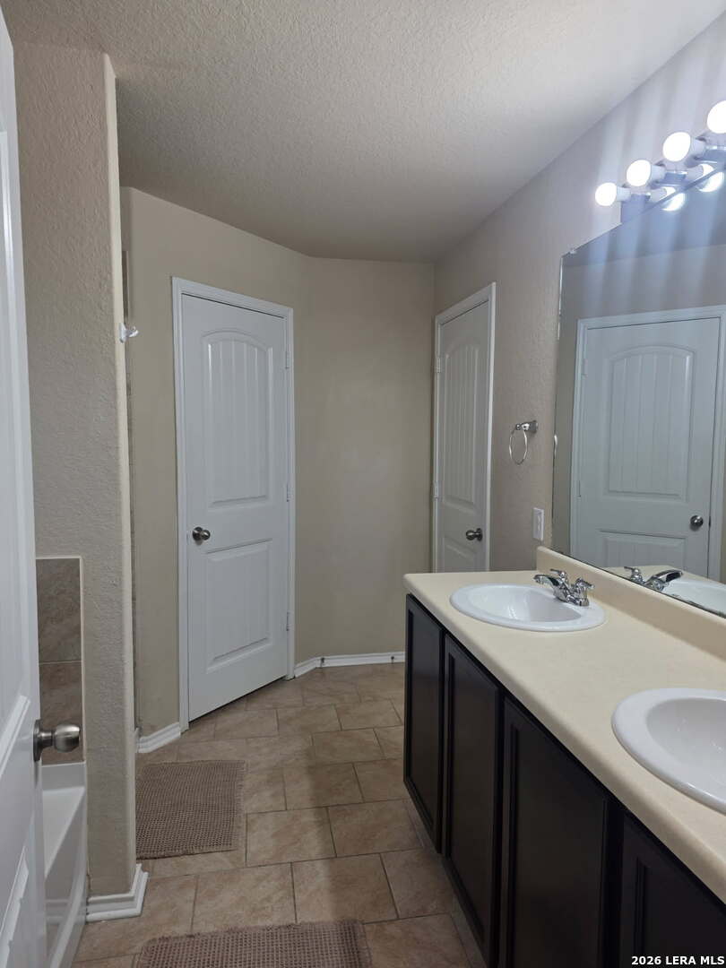 6024 Harvest Ranch San Antonio, TX 78244 - Photo 13 of 31 a bathroom with a sink and a mirror