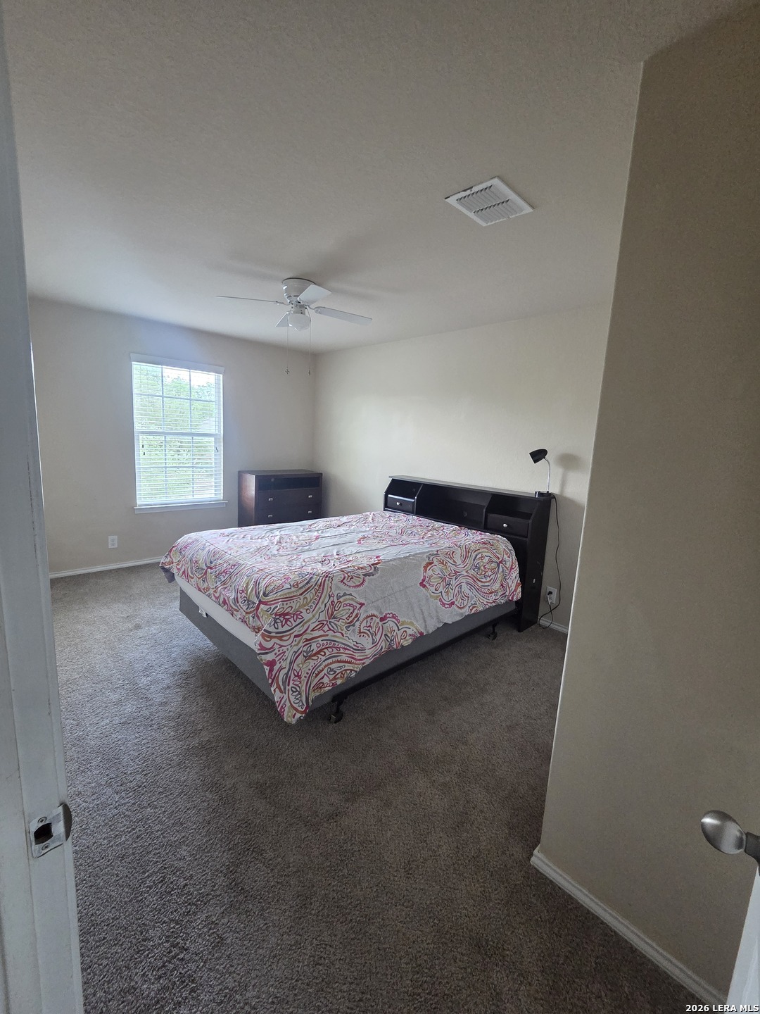 6024 Harvest Ranch San Antonio, TX 78244 - Photo 27 of 31 a bedroom with a bed and window