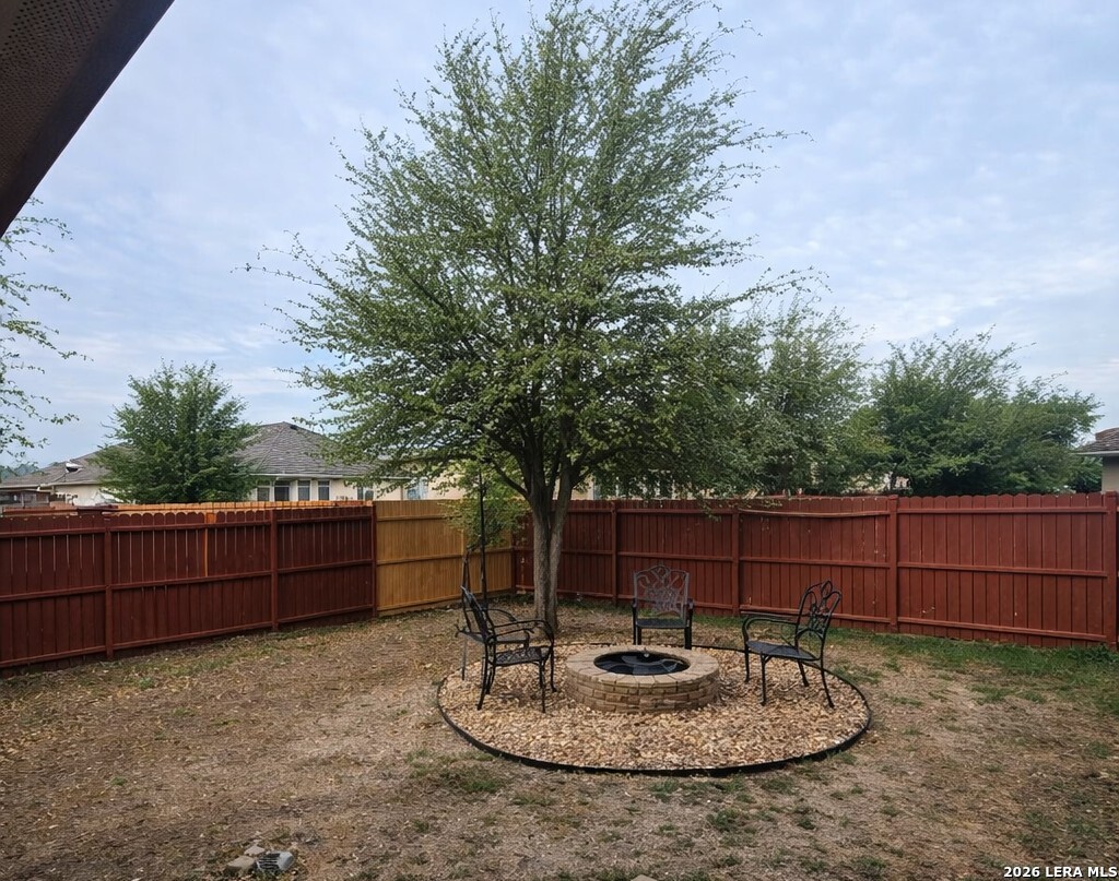 6024 Harvest Ranch San Antonio, TX 78244 - Photo 31 of 31 a backyard of a house with a table and chairs