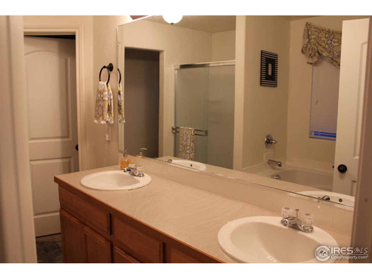2259 80th Avenue Greeley, CO 80634 - Photo 12 of 21 a bathroom with a sink and a mirror