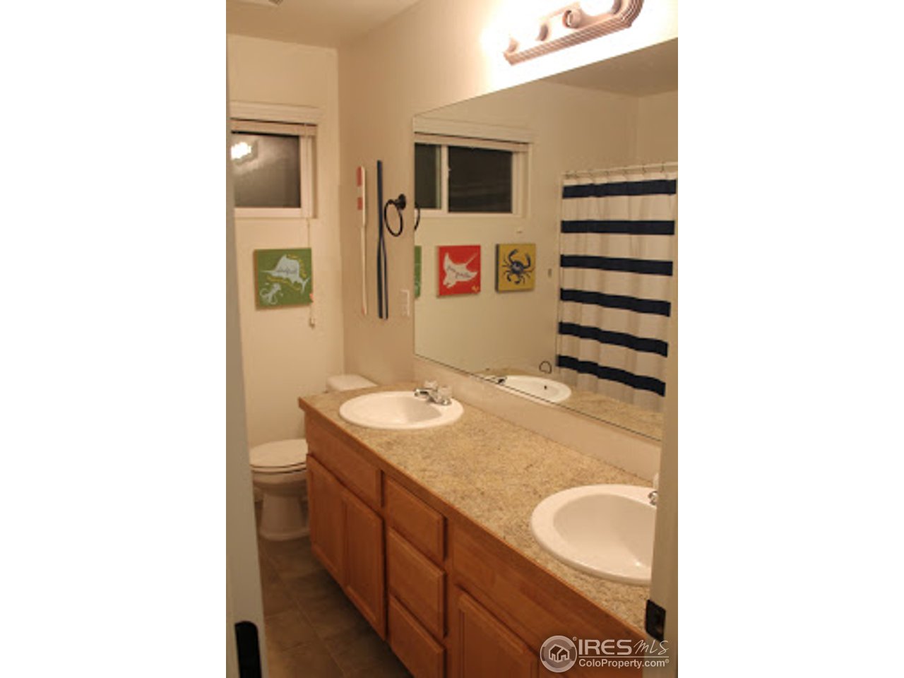 2259 80th Avenue Greeley, CO 80634 - Photo 14 of 21 a bathroom with a sink a toilet and a shower
