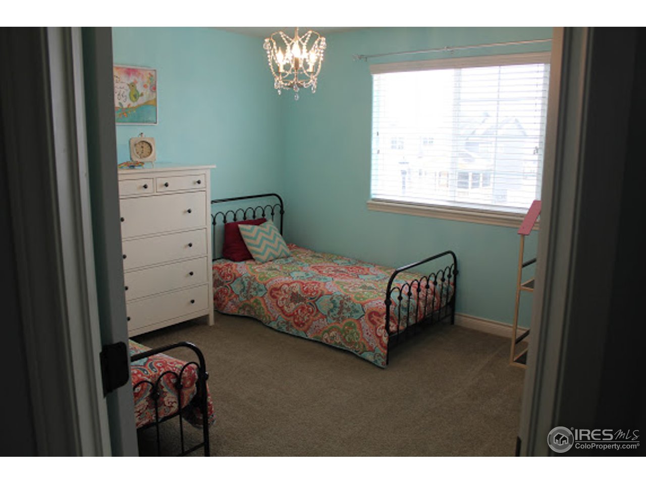 2259 80th Avenue Greeley, CO 80634 - Photo 15 of 21 a bedroom with a bed and a window