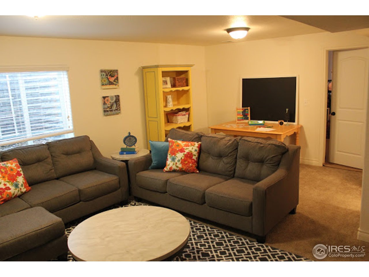 2259 80th Avenue Greeley, CO 80634 - Photo 18 of 21 a living room with furniture and a flat screen tv