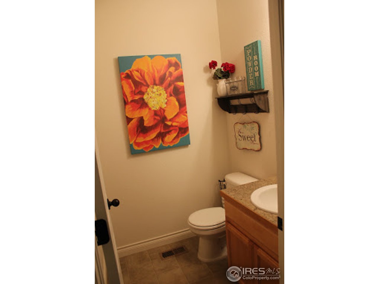 2259 80th Avenue Greeley, CO 80634 - Photo 7 of 21 a bathroom with a toilet and a shower curtain