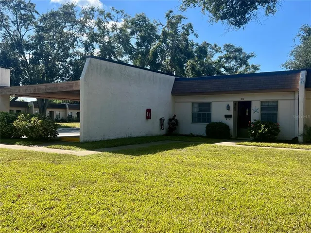 a view of a house with pool and garden