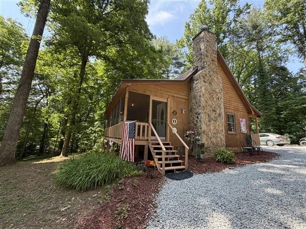 238 Trails End Road Blue Ridge, GA 30513 - Photo 2 of 32 a view of house with a big yard and potted plants and large trees