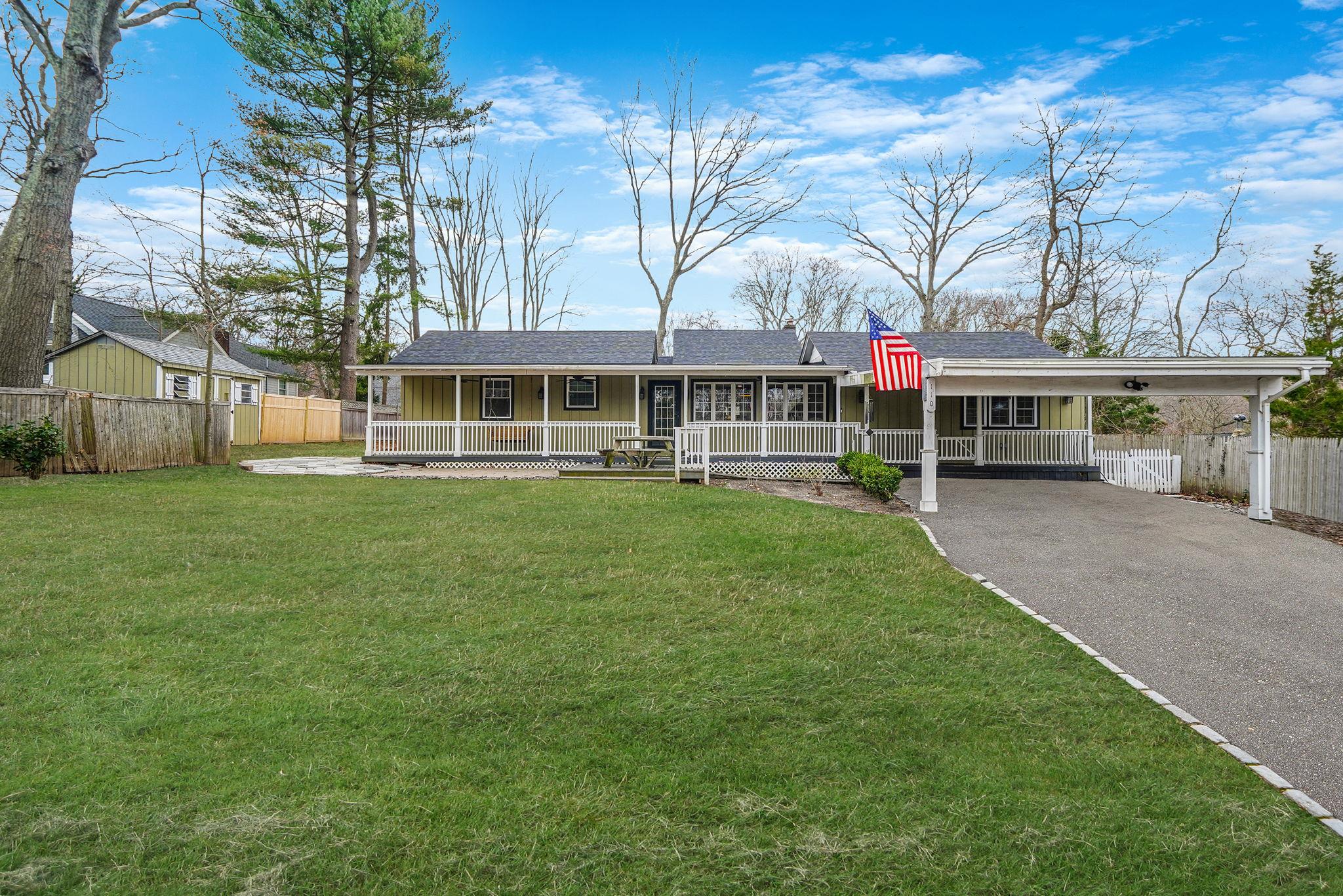 a front view of a house with a yard table and chairs