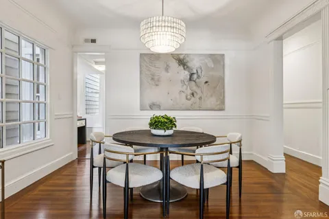 a view of a dining room with furniture window and wooden floor