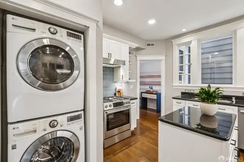 a kitchen with stainless steel appliances granite countertop a sink stove and cabinets